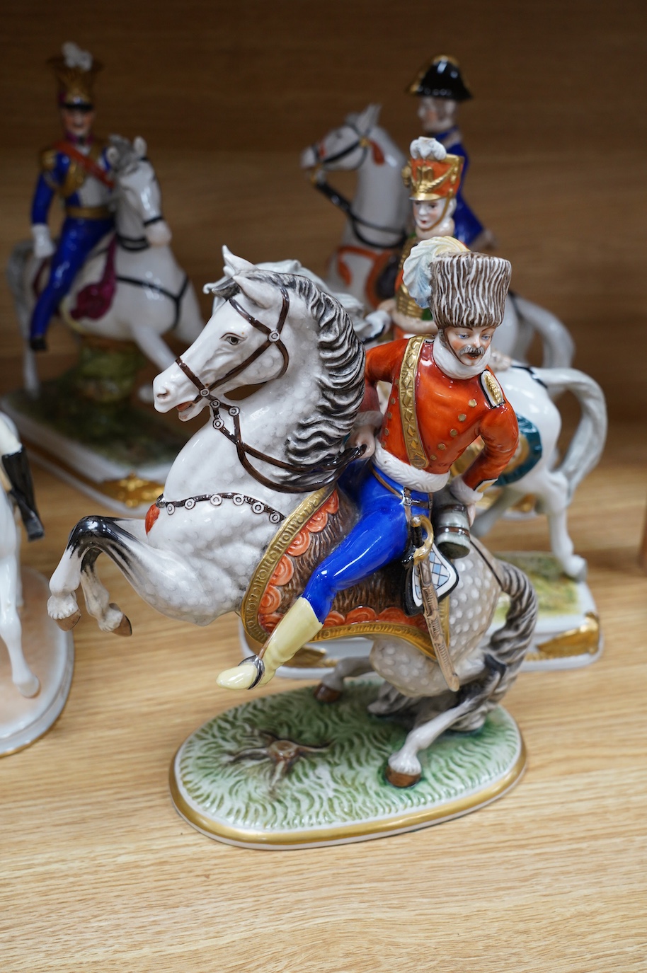 A group of eight Italian porcelain figures on horseback, tallest 30cm. Condition - fair